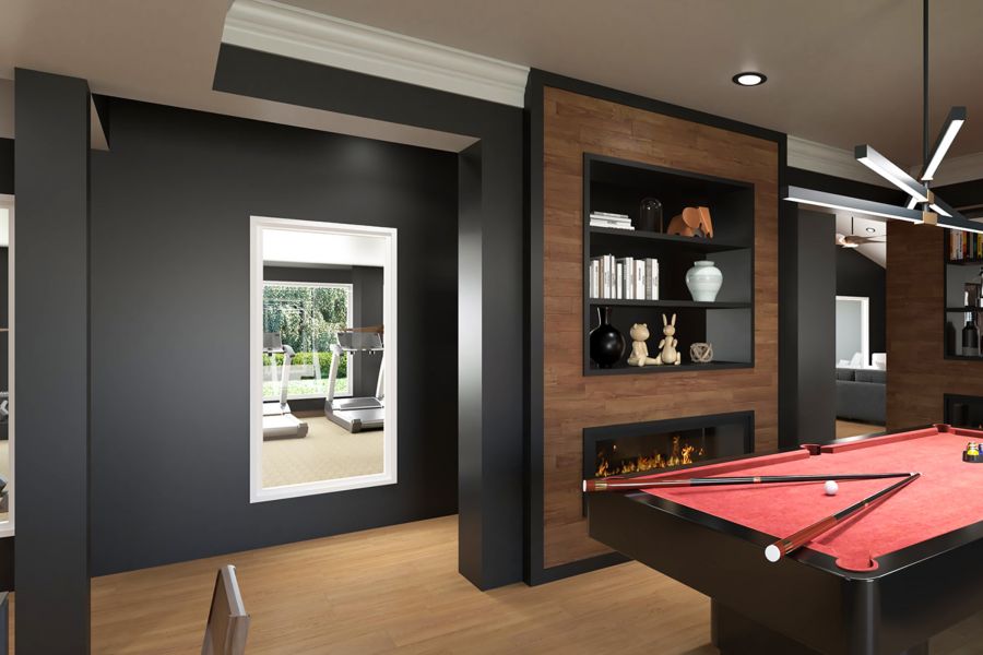 Attain on 5th apartment homes with Modern game room with a red pool table, built-in shelves, fireplace, and a view into a gym with exercise equipment.