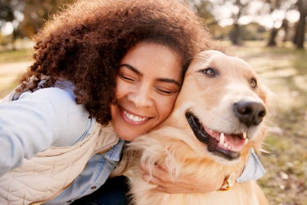 Selfie, hug and woman in park, dog and bonding together with nature, happiness and kindness. Pet lover, person and girl with animal, best friend and cheerful with memory, outdoor and profile picture